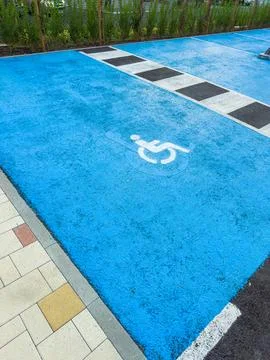 Parking space marked for disabled access in a public area with bright colors Stock Photos