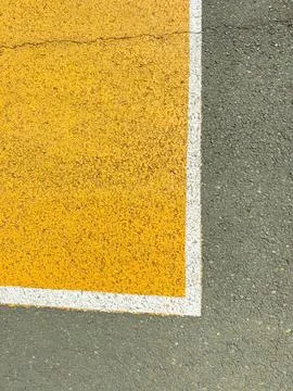 A parking space is outlined with bright yellow paint on the asphalt surface.  Foto stock