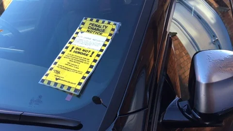 Parking Ticket on Car Windscreen Window - Driver recieving Fine Stock Footage