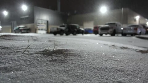 Parking of warehouse facility covered in snow low level video at night Stock Footage 274179638