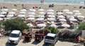 Parking zone of sandy beach with sunbeds full of people, Coral Bay, Cyprus HD Footage