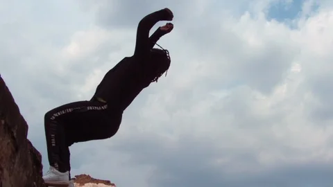 Parkour athlete executes backwards flip super slow motion Stock Footage 117676002