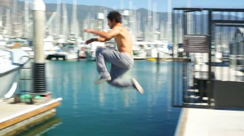 Parkour Athlete Jumps Across the Dock Stock Footage
