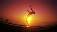 Parkour Free Runner Runs And Jumps Backflip At Summer Beach Sunset. Steadicam Stock Footage