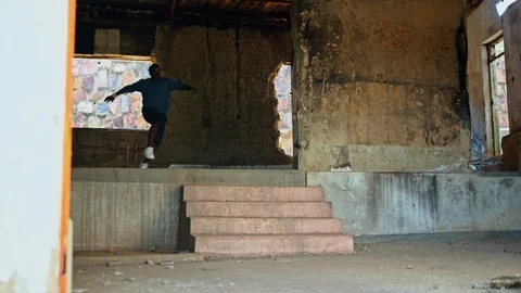Parkour performer practicing in the warehouse Stock Footage 117689376