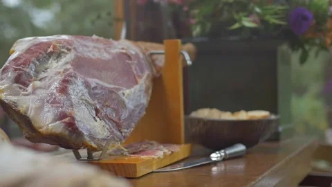 Parma ham and bread appetisers on table with flowers Stock Footage 255833702