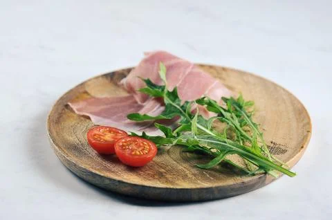 Parma ham, cherry tomatoes and arugula Stock Photos