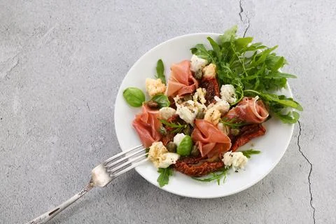 Parma ham with mozzarella and sun-dried tomatoes Stock Photos