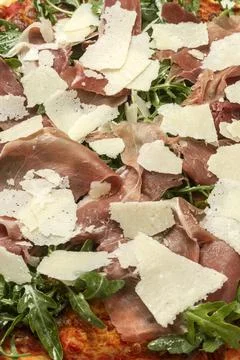 Parma ham, rocket and parmesan cheese gourmet pizza close up Stock Photos