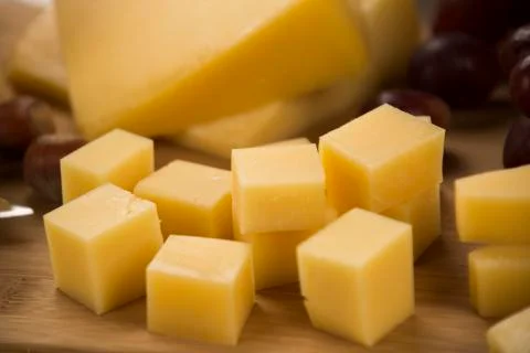 Parmesan cheese on a cutting board. Stock Photos