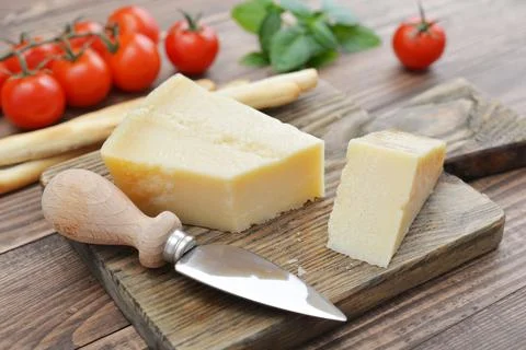 Parmesan cheese on cutting board Stock Photos