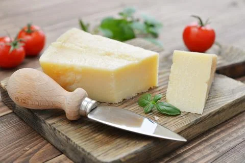 Parmesan cheese on cutting board Fotos Stock