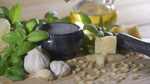 Parmesan cheese, pine nuts, sea salt and garlic for basil pesto sauce making on Stock-Footage 105808289