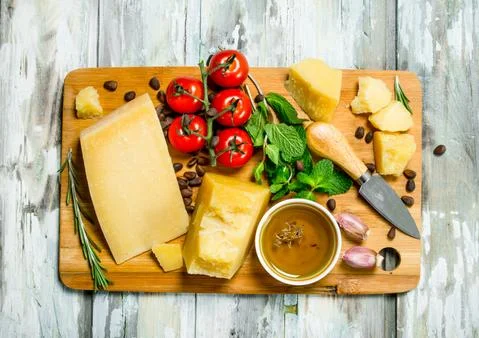 Parmesan cheese with tomatoes, pine nuts and olive oil. Stock Photos