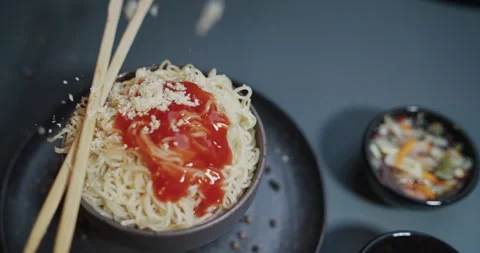 Parmesan is falling on spaghetti bowl plate with cheese and chinese sticks in Stock Footage 330118428