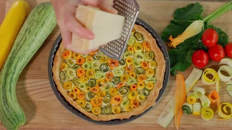 Parmesan is grated onto the hot pie Stock Footage 264141704