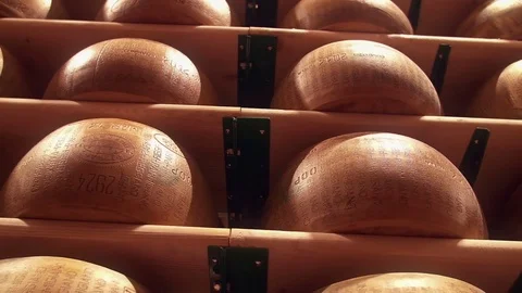 Parmesan wheels cheese forms seasoning at a Parmigiano Reggiano factory Stock Footage 69712203