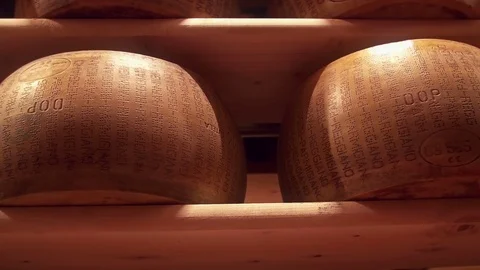 Parmesan wheels cheese forms seasoning at a Parmigiano Reggiano factory Stock Footage 69712229