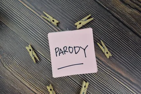 Parody write on sticky notes isolated on Wooden Table. Stock Photos