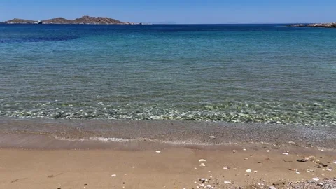 Paros Island,slow motion of the crystal clear waves washing the sandy beach on Video stock 331075652