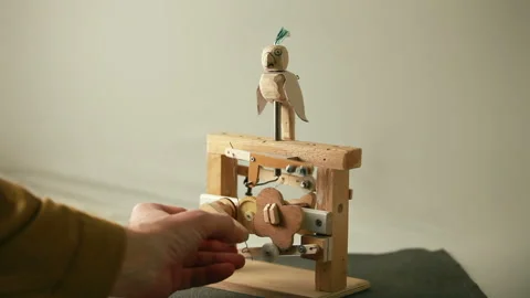 Parrot flaps its wings turns its head, funny wooden toy Stock Footage 261459987