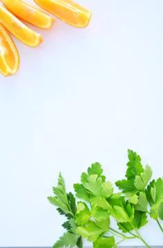 Parsley leaves and fresh cutted orange on a white Cyprus May 2020 Stock Photos