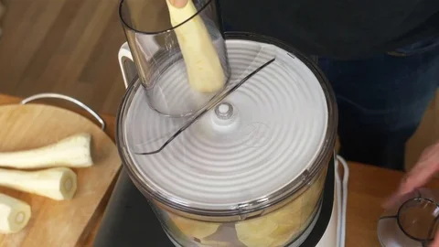 Parsnip being sliced in a food processor Stock Footage 72468207