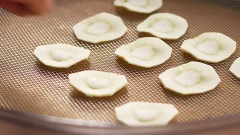 Parsnip slices being put on a drying rack Stock Footage 72508684