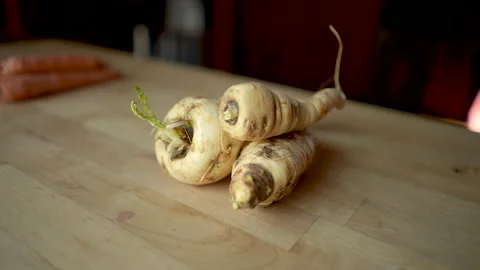 Parsnips on a wooden table or cutting board Stock Footage 145743701