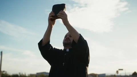 Parson Lifting Up The Bible Towards The Sea Stock Footage 310678870