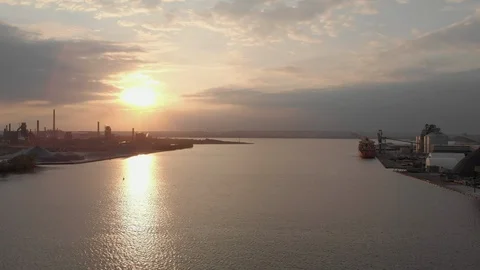 Part 1 long reverse over hamilton harbour past several large ships at sunset. Video stock 112616991