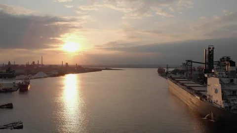 Part 2 long reverse over hamilton harbour past several large ships at sunset. Video stock 112616956