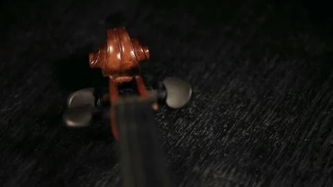 Part of aged violin on black background Stock Footage 73001991