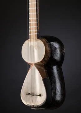 Part ancient Asian stringed musical instrument on black background with bac.. Stock Photos