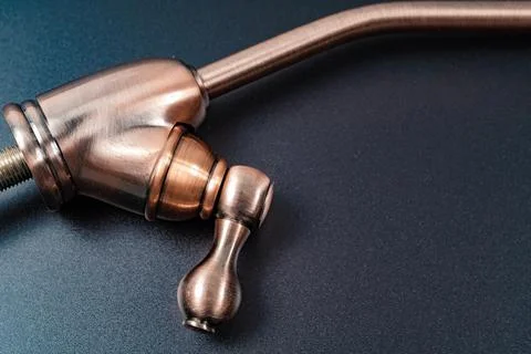 Part of Brass tap to filter drinking water on a black background. Stock Photos