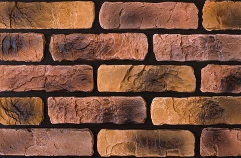 Part of a brick wall on a black background Stock Photos
