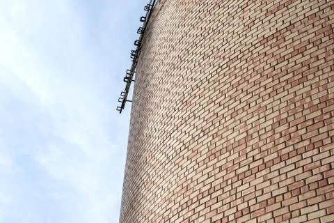 Part of bricks wall on sky background Stock Photos