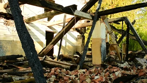 Part of the building after a fire, a blockage of burnt logs and bricks Stock Footage 138420083