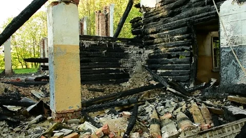 Part of the building after the fire, burnt logs, brick columns Stock Footage 138419763