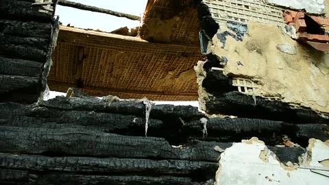Part of the building after the fire, burnt logs wall with the remains of plaster Stock Footage 138419846