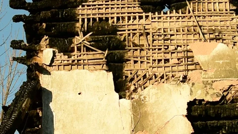 Part of a building after a fire, a burnt wall with remnants of plaster Stock Footage 138420077