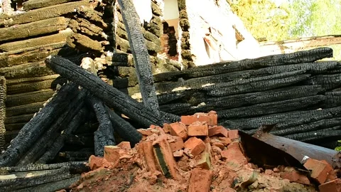Part of the building after a fire, a burnt log wall and a brick heap Stock Footage 138420114