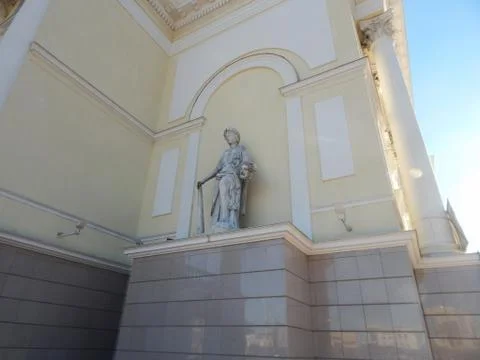 Part of the building of a dramatic theater with a statue Stock Photos