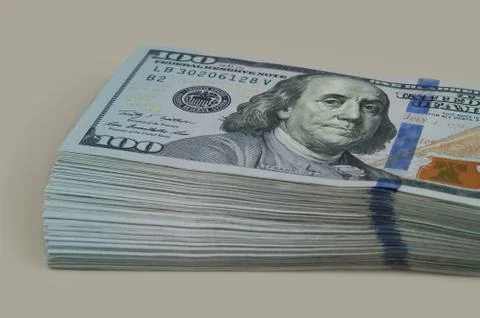 Part of the bundle with a bill shift of one hundred dollars. On a gray backgr Stock Photos