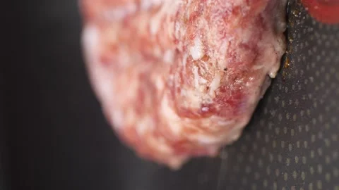 Part of a burger patty made of beef and pork, which is fried in a pan. Stock Footage 229488182