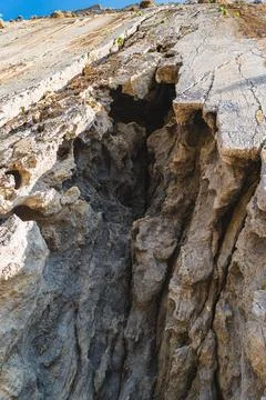 Part of a cave in a vertical rock face Stock Photos