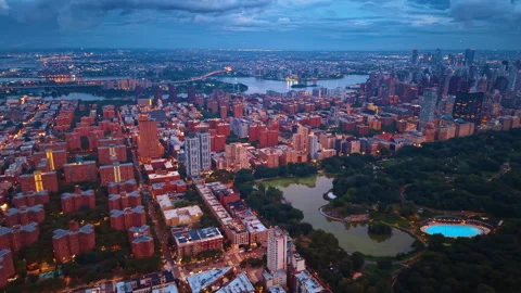 Part of Central Park with lush greenery and ponds surrounded by dense cityscape Stock Footage 346610478