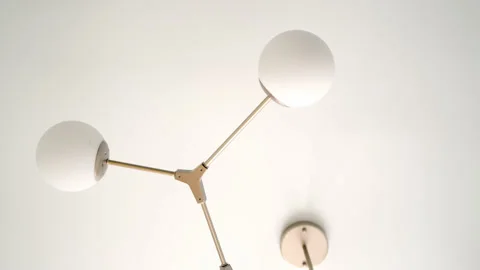 Part of chandelier in frame on ceiling, beautiful golden color with round shades Stock Footage 197191349