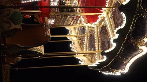 Part of Children's Carousel close up spinning at an amusement park at night Video stock 220620603