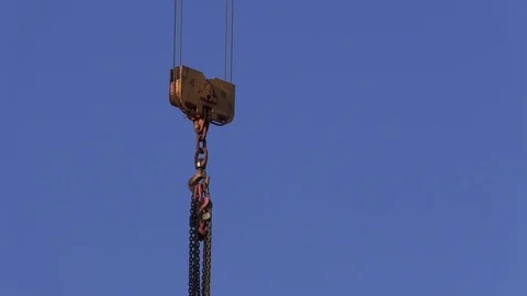 Part of a construction crane with chains attached to lift weights, blue sky Stock Footage 81474327